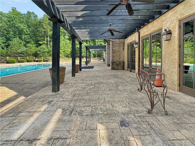 view of patio with ceiling fan and a pergola