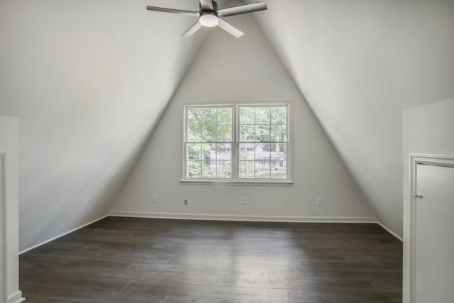 additional living space featuring vaulted ceiling, ceiling fan, dark wood-style flooring, and baseboards