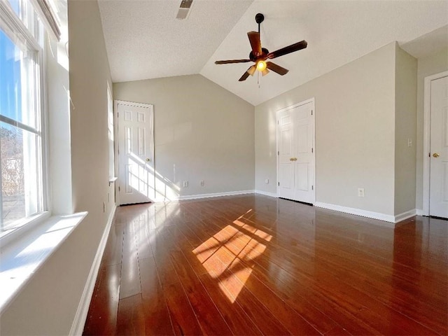 spare room with plenty of natural light, ceiling fan, and wood-type flooring