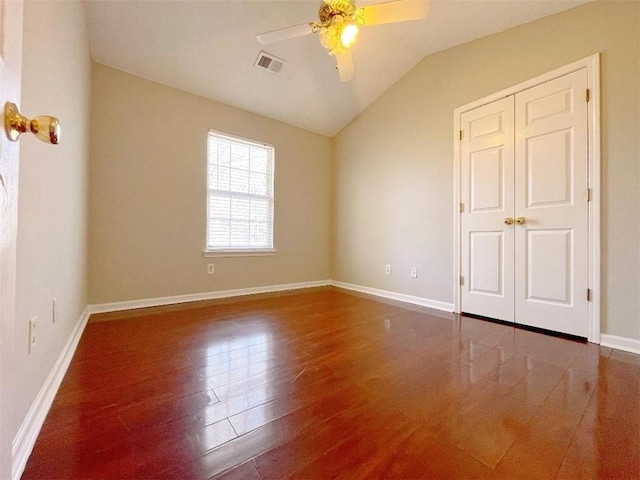 unfurnished bedroom featuring a closet, lofted ceiling, ceiling fan, and hardwood / wood-style floors