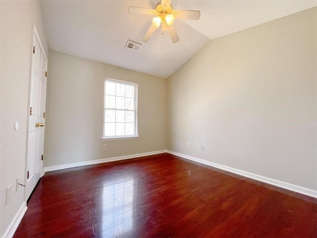 unfurnished room featuring ceiling fan, a textured ceiling, dark hardwood / wood-style flooring, and lofted ceiling