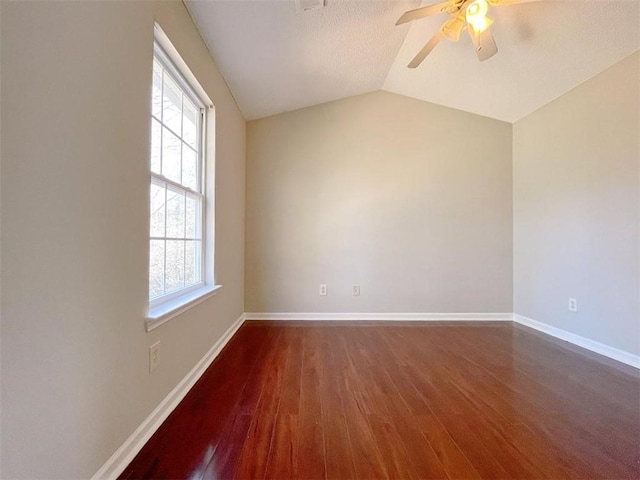 spare room with ceiling fan, wood-type flooring, and vaulted ceiling