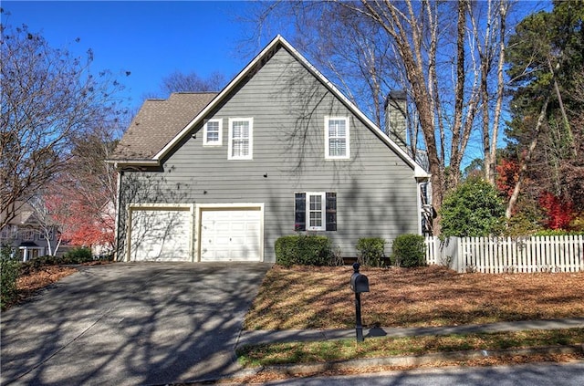 view of side of property with a garage