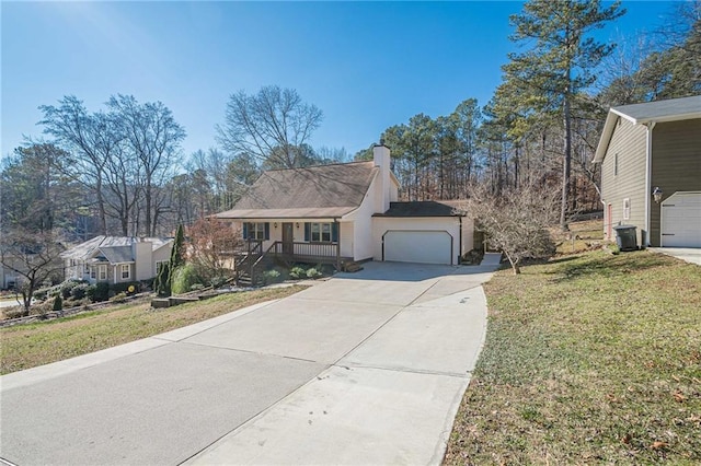 view of front of home with a porch, a garage, and a front lawn