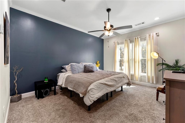 bedroom featuring baseboards, carpet floors, visible vents, and crown molding