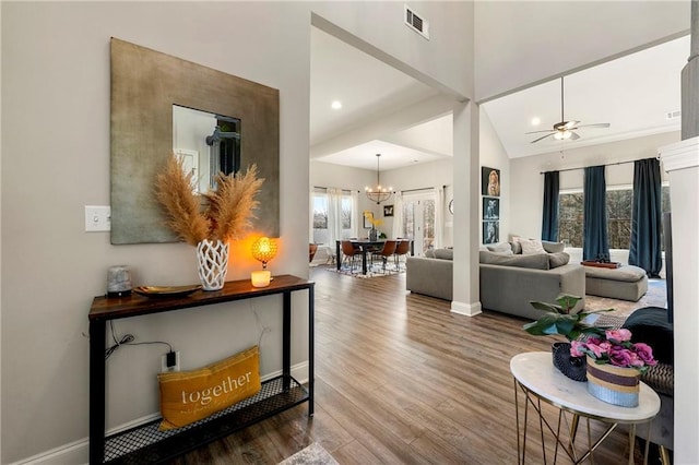 interior space with a healthy amount of sunlight, visible vents, baseboards, and wood finished floors