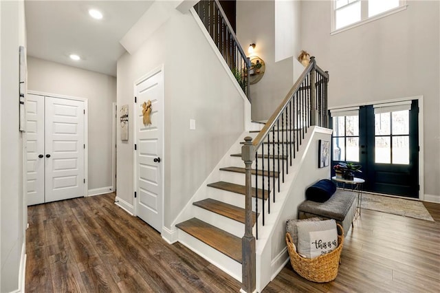 foyer featuring plenty of natural light, baseboards, wood finished floors, and french doors