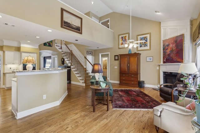 living room featuring light hardwood / wood-style flooring and high vaulted ceiling