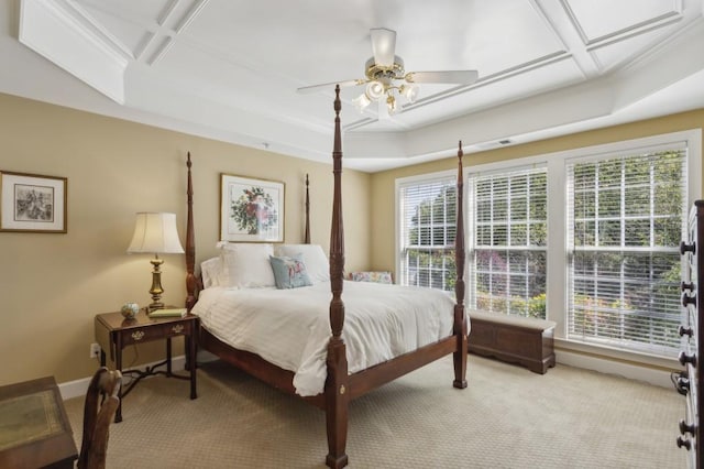 carpeted bedroom with coffered ceiling and ceiling fan