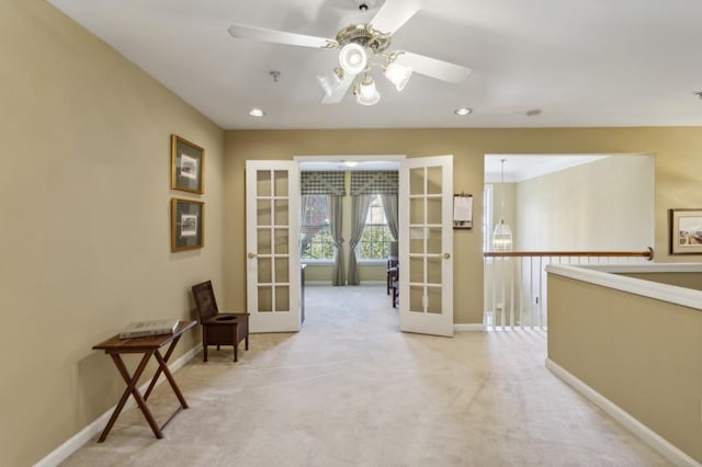 interior space with french doors and light colored carpet