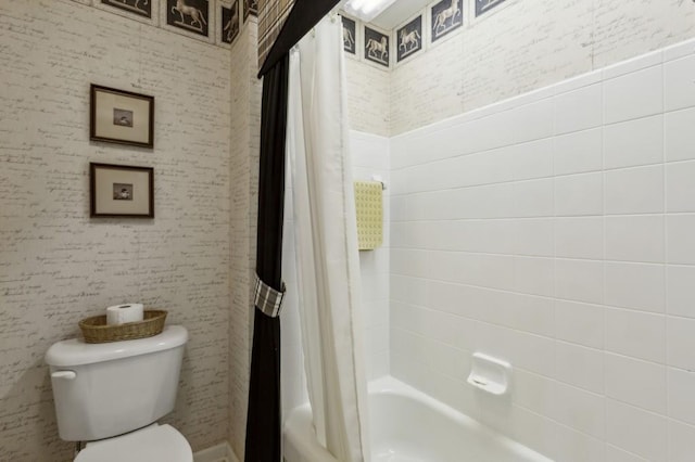 bathroom with toilet and shower / tub combo