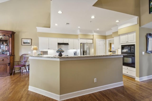 kitchen featuring a spacious island, black appliances, white cabinets, and dark hardwood / wood-style floors