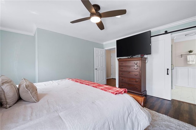 1223 Whitlock Ridge Dr SW, Marietta, GA 30064 - bedroom with wood finished floors, ornamental molding, a barn door, and a ceiling fan