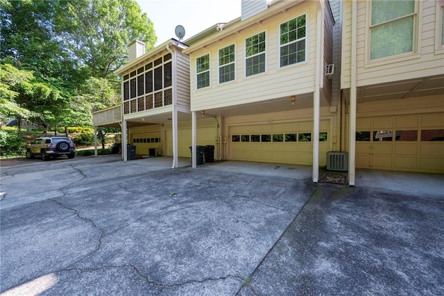 1223 Whitlock Ridge Dr SW, Marietta, GA 30064 - rear view of property featuring driveway, an attached garage, a yard, and a chimney
