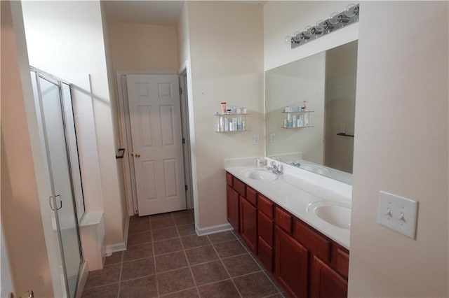 bathroom with tile patterned floors, an enclosed shower, and vanity