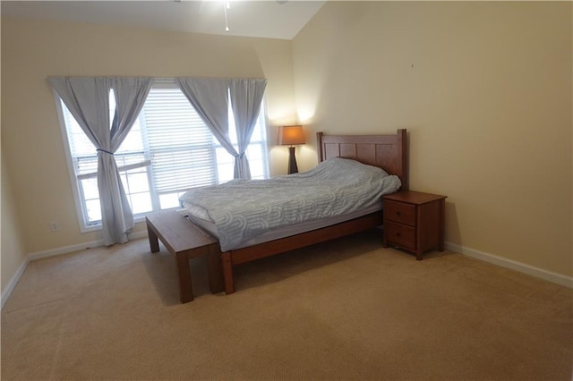 carpeted bedroom with vaulted ceiling