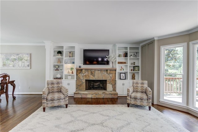 4246 Stilson Cir, Peachtree Corners, GA 30092 - living area featuring wood finished floors, ornamental molding, a stone fireplace, and baseboards