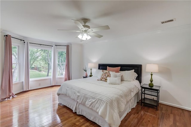 4246 Stilson Cir, Peachtree Corners, GA 30092 - bedroom with multiple windows, wood finished floors, ornamental molding, baseboards, and a ceiling fan