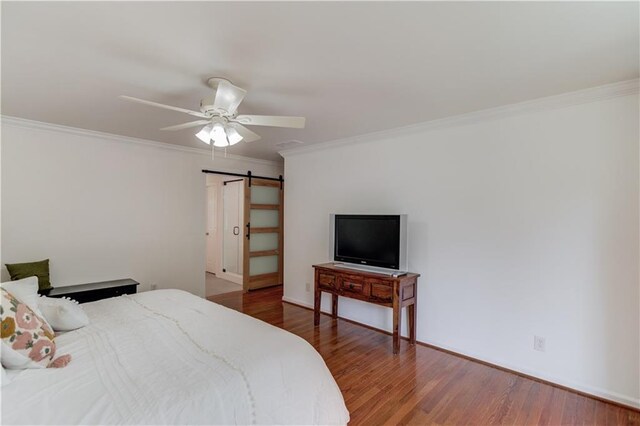 4246 Stilson Cir, Peachtree Corners, GA 30092 - bedroom featuring a barn door, ornamental molding, wood finished floors, and a ceiling fan