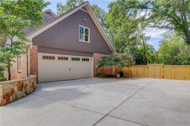 4246 Stilson Cir, Peachtree Corners, GA 30092 - view of property exterior with a gate, concrete driveway, and a garage
