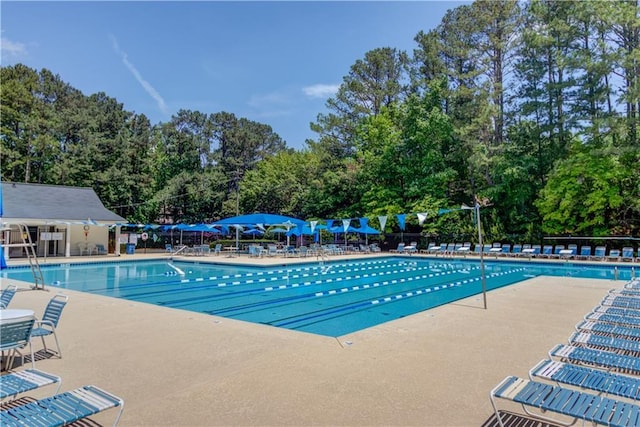 4246 Stilson Cir, Peachtree Corners, GA 30092 - community pool with a patio area and view of wooded area