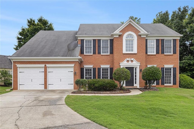 505 Stedford Ln, Duluth, GA 30097 - colonial house featuring a front lawn, concrete driveway, a garage, and brick siding