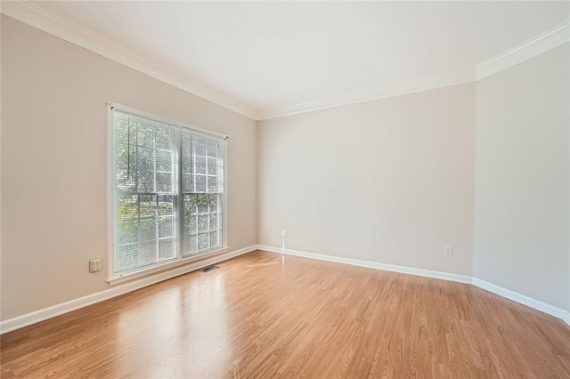 unfurnished room with light hardwood / wood-style flooring and ornamental molding