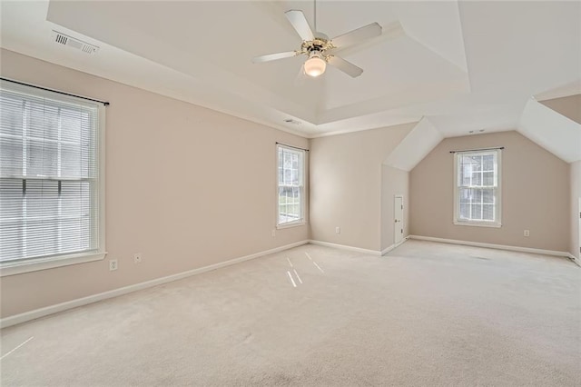 additional living space with light carpet, vaulted ceiling, and ceiling fan