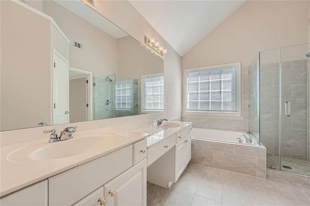 bathroom featuring vanity, vaulted ceiling, tile patterned floors, and shower with separate bathtub