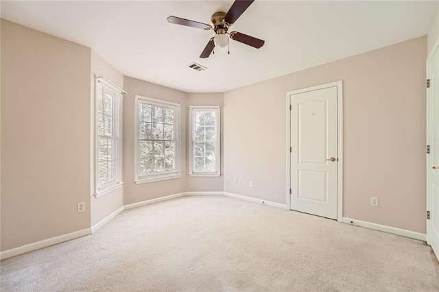 empty room with light colored carpet and ceiling fan