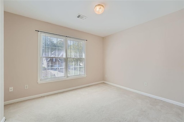 spare room with light colored carpet