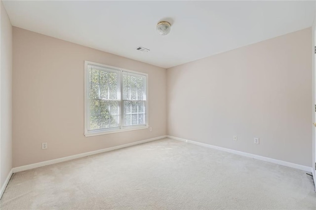 empty room featuring light carpet