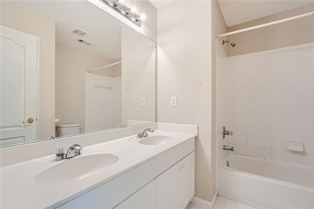 full bathroom with vanity, tile patterned floors, toilet, and tiled shower / bath