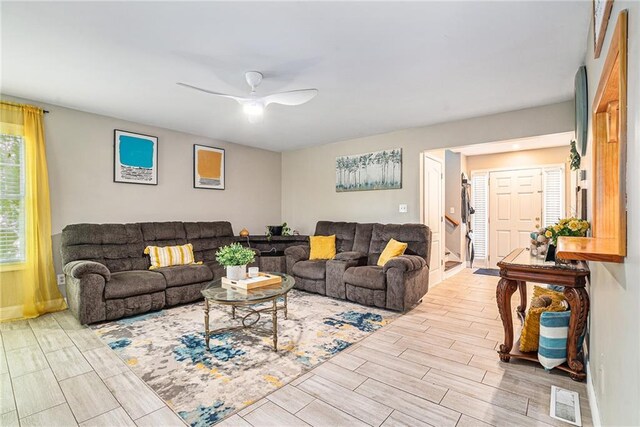 living room with ceiling fan and light hardwood / wood-style floors