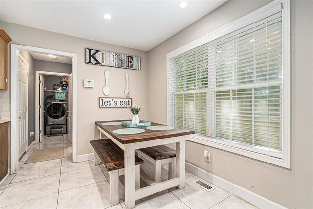 dining area featuring plenty of natural light and light tile patterned flooring