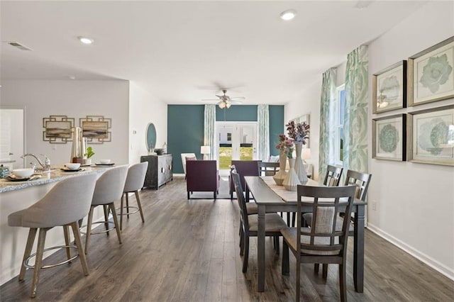 dining area with french doors, dark wood-type flooring, and ceiling fan