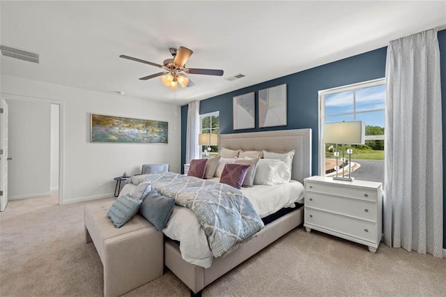 bedroom with ceiling fan and light carpet