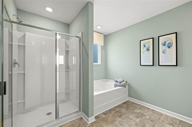 12000 Conrad, Hampton, GA 30228 - bathroom with baseboards, a stall shower, and a garden tub