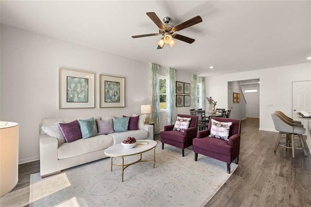 living room featuring ceiling fan and hardwood / wood-style flooring