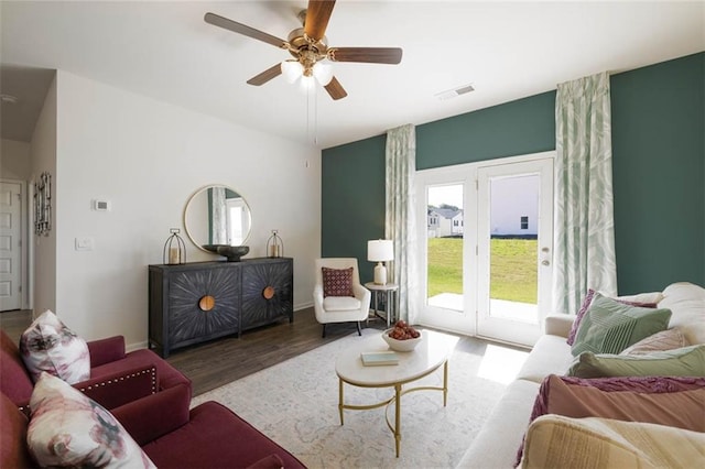 living room featuring ceiling fan and hardwood / wood-style flooring