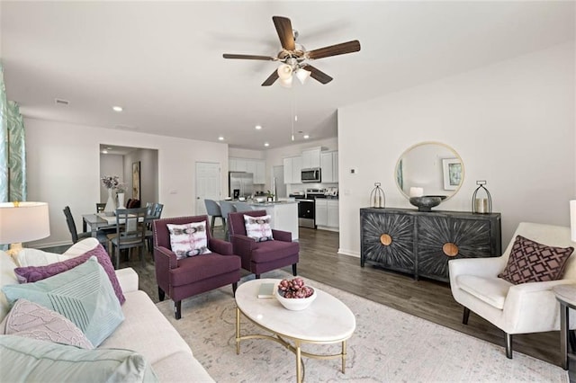 living room with ceiling fan and wood-type flooring