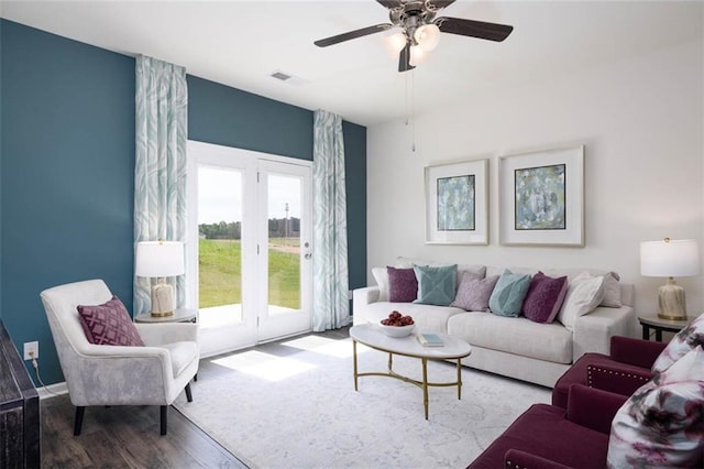 living room featuring ceiling fan and hardwood / wood-style flooring