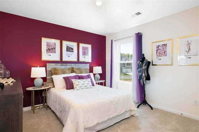 bedroom featuring light colored carpet