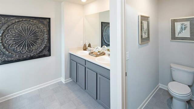 12000 Conrad, Hampton, GA 30228 - bathroom featuring toilet, double vanity, and baseboards