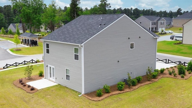 exterior space with cooling unit and a yard