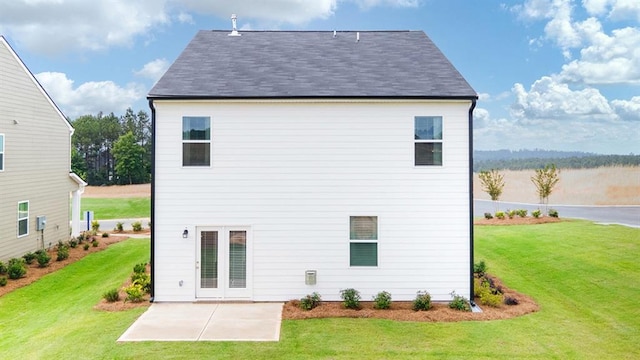 rear view of property featuring a lawn and a patio