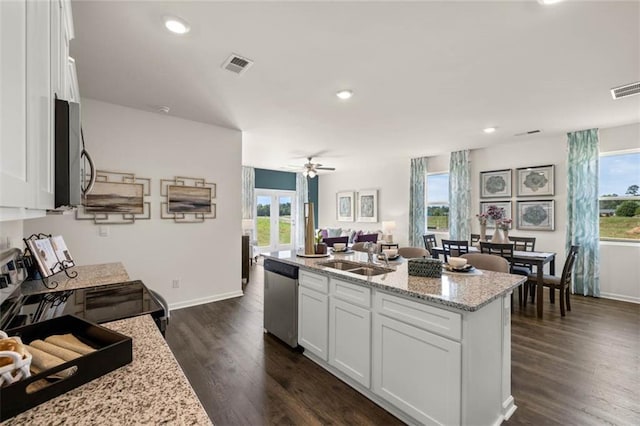 kitchen with appliances with stainless steel finishes, dark hardwood / wood-style floors, and white cabinetry