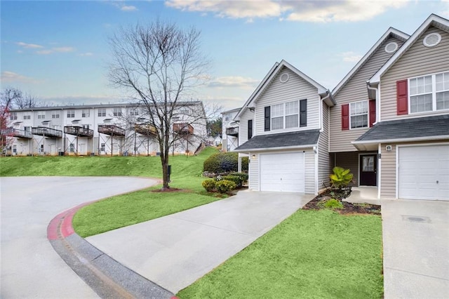 view of front of property with an attached garage, concrete driveway, and a front lawn