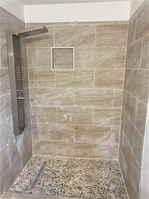 bathroom with tiled shower