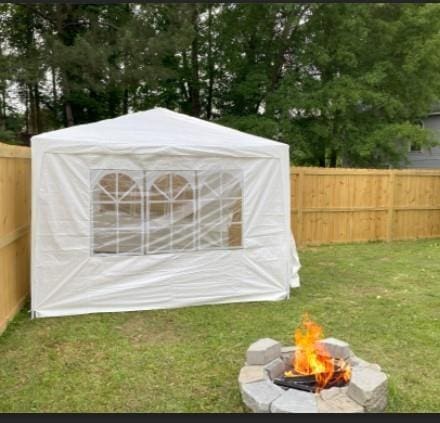 view of outbuilding with a lawn and a fire pit